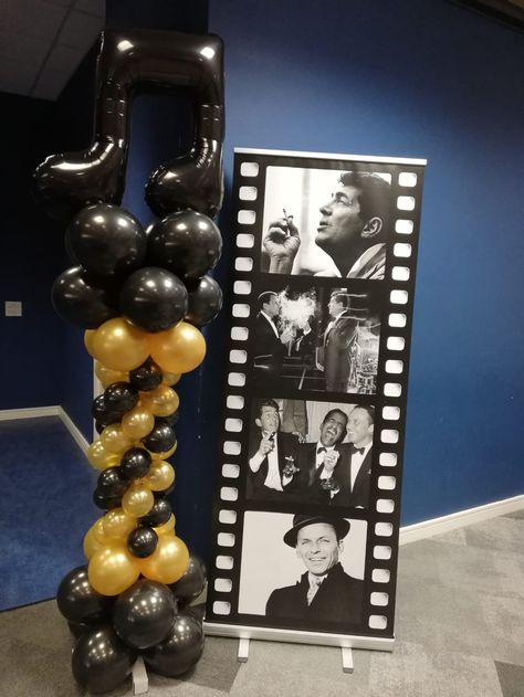 Hollywood Musical Black & Gold Spiral Column used here as an entrance decoration to the photobooth area.  Want to create a dramatic entrance to your event, add focus to an area such as a photo booth or promotional zone and really draw attention... this is an ideal decoration to do all of this.   Standing 6ft tall it will be seen from a distance and can created in your colours and desired theme so that it is unique to you! Spiral Column, Cinema Party, Happy Birthday Blue, Bollywood Theme, Hollywood Party Theme, Black And Gold Balloons, Dramatic Entrance, Music Themed Parties, Balloons Decorations