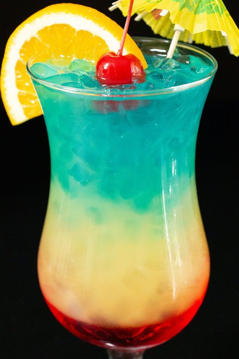 Impress your friends at your next happy hour at home with this stunning rainbow paradise layered cocktail. Sweet, tropical flavors make this an easy to drink cocktail perfect for a heatwave or summer. Taste The Rainbow Drink, Rainbow Paradise Cocktail, Luau Drinks, Paradise Drink, Paradise Cocktail, Hawaiian Drinks, Rainbow Cocktail, Layered Cocktails, Happy Hour At Home