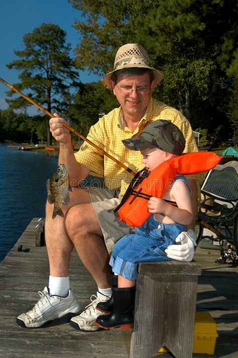 Fishing with Grandpa. Young boy fishes with his grandpa. He has caught a bream a , #Ad, #grandpa, #fishes, #bream, #caught, #Grandpa #ad Fishing With Grandpa, Black Rubber Boots, Fishing Grandpa, Rubber Boot, Rubber Boots, Denim Overalls, Black Rubber, Royalty Free Stock Photos, Fishing