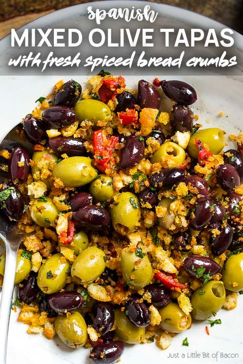 For a fun appetizer recipe, toss green and black olives with fresh spiced bread crumbs in this easy Spanish olive tapas! Perfect for dinner parties, holidays, and snacks. | justalittlebitofbacon.com #christmasrecipes #newyearsrecipes #holidayrecipes #tapasrecipes #spanishrecipes #tapas #olives Vegetable Tapas Recipes, Spanish Olives Recipes, Meditterean Food, Spanish Salads, Authentic Spanish Tapas Recipes, Marinated Olives Recipe, Tapas Olives, Spanish Salad, Spiced Bread