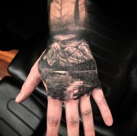 Hand tattoo of mountains, trees and a lake. Mountain Tattoo On Hand, Outdoor Hand Tattoo, Mountain Hand Tattoo, Nature Hand Tattoo, Outdoor Tattoo, Hand Tatto, Mountain Tattoo, Hand Tattoos For Guys, Male Hands