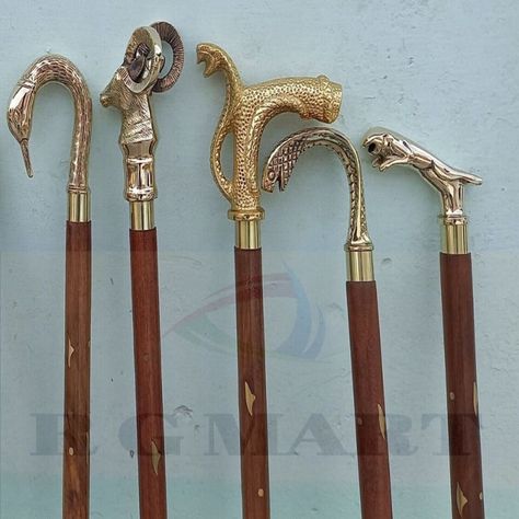 Elevate your style with these antique reproduction walking sticks! Made with brass and wood, these Victorian-inspired canes are perfect for everyday use. Each set includes 5 unique designs, such as an elegant brass handle knob and a vintage horse hames handle. Handmade in India, these walking sticks are the perfect addition to your collection. #walkingsticks #victorianstyle #handmade #brasshandle #giftidea #Reproduction Antique Walking Cane, Wood Hiking Stick, Medieval Home, Medieval Home Decor, Unique Walking Sticks, Wooden Canes, Cane Handles, Walking Sticks And Canes, Canes & Walking Sticks