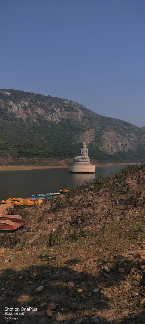 Ghora Katora Lake is a picturesque body of water surrounded by mountains on three sides, and in the centre of the lake sits a stunning huge Buddha statue. The distance to the lake is roughly 6.5 kilometres from Shanti Stupa, and the route there passes through a forest. You can go there by using only e-rickshaw vehicle standing at Shanti Stupa, they will take 100 rupees per person with the return back Location📍: Ghora Katora Dam, Rajgir Opening Hours : from 7:00 am to 3:00 pm. Rajgir Bihar, Photoshop Digital Background, Body Of Water, Opening Hours, Digital Background, Instagram Pictures, Buddha Statue, Places To Visit, Forest