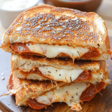 Delicious Pizza Grilled Cheese with melty cheese, pepperoni, and marinara sauce. A fun twist on classic grilled cheese. Pizza Grilled Cheese Recipes, Pizza Grilled Cheese Sandwich, Grilled Cheese Recipe, Pizza Grilled Cheese, Classic Grilled Cheese, Craving Pizza, Grilled Cheese Recipes, Melty Cheese, Delicious Sandwiches