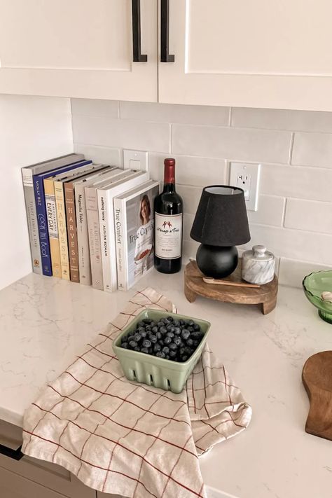 Cookbook Display In Kitchen Counter, Countertop Flour Storage, Cook Books On Kitchen Counter, Cook Book Display On Counter, Decorate Bar Counter Top, Bar Centerpieces Kitchen, Books On Kitchen Counter, L Shaped Kitchen Counter Decor, Styling Cookbooks In Kitchen