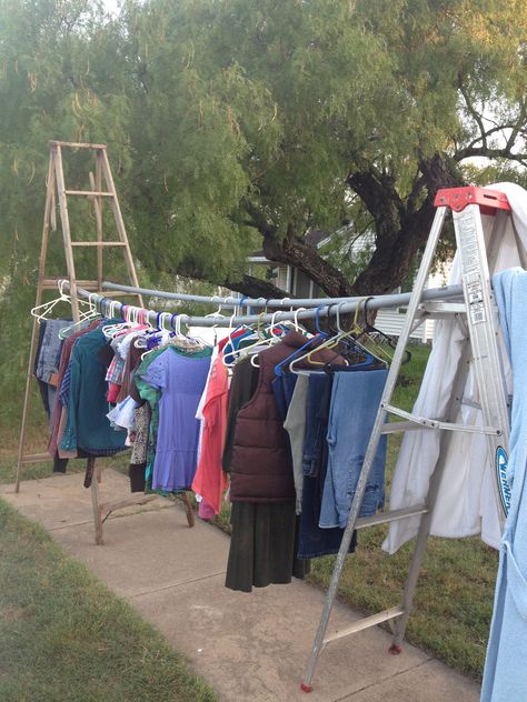 Great way to display hang up clothes for a garage sale. The morning of the sale we found PVC pipe. Wooden stick would not have caused sag but it did the trick. Hang Clothes For Garage Sale, Yardsale Tips, Yardsale Ideas, Garage Sale Clothes, Yard Sale Clothes, Yard Sale Clothes Rack, Yard Sale Display, Display Clothes, To Hang Clothes