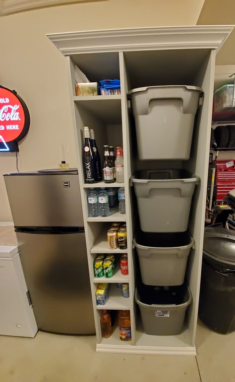 We have a recycling station that has four bins for your cans and bottle and cardboard and six shelves for pop, water or beer or wine for that garage fridge.  The unit is made of 3/4 MDF and is paintable and also has crown molding.  It is very useful and is a space saver.  The bins are taken right to curb for pick up. Fridge And Freezer In Garage, Bottle And Can Recycling Storage, Small Space Recycling Station, Pull Out Tote Storage, Recycle Station Diy, Bottle Recycling Storage, Garage Cooler Storage, Garage Refrigerator Organization, Recycling Organization Garage