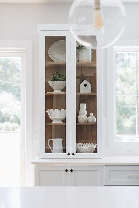 Stained oak shelves inside a glass-front china cabinet add a warm farmhouse touch styled with white ceramic decor. Glass Cabinets Display Ideas, Kitchen Glass Cabinets Display Ideas, Kitchen Glass Cabinets Display, Kitchen Glass Cabinet, Kitchen Glass Cabinets, Kitchen Cabinet Display, White China Cabinets, Glass Kitchen Cabinet, Built In China Cabinet