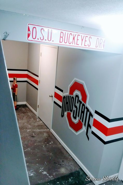 This is a wall from a basement Serena Shields painted with an Ohio State Buckeye theme Ohio State Bar Ideas, Ohio State Buckeyes Room Ideas Man Cave, Ohio State Buckeyes Man Cave, Ohio State Buckeyes Basement Ideas, Ohio State Basement, Ohio State Bedroom, Ohio State Buckeyes Room, 49ers Room, Ohio State Rooms