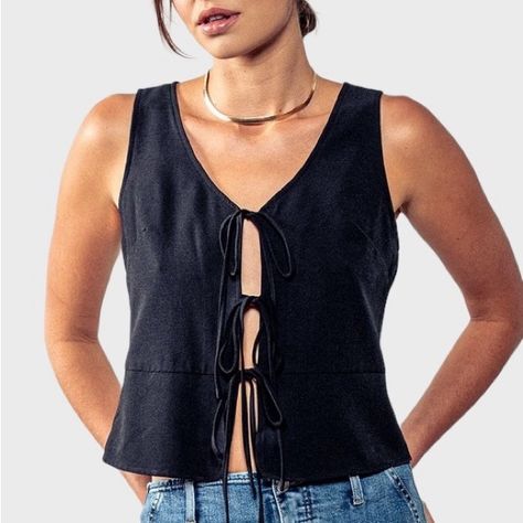 The Francesca Tie Front Vest Top Is A Chic Essential For Your Wardrobe. Three Playful Bow Ties Grace The Front, Adding A Feminine Touch. This Trendy Top Is Perfect For Any Occasion, From Casual Outing To Evening Affairs. Tie Front Sleeveless 100% Polyester Size Up For A Looser Fit