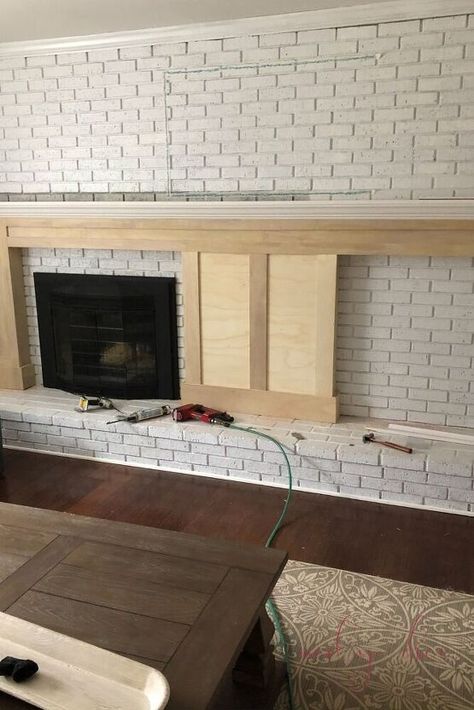 In this tutorial, you'll learn how to build a DIY fireplace mantel with built in bookcases. Step 1: Do a Mockup with TapeAs you can see in this image, we used masking tape to a mock up of where the mantel and built ins would go before we started the project!Step 2: Gather MaterialsFor this project, we used: (3) 4×8 sheets (1/2 inch) of Ecuadorian Plywood – (used for the majority of the project, for the mantel including the mantel posts and as backboard to connect the bookcases & man… Brick Fireplace With Brick Mantle, Extra Wide Fireplace Mantle, Off Center Fireplaces, Built In Brick Fireplace, Fireplace Wall Remodel, Brick Wall With Fireplace Makeover, Old Fireplace Remodel, Whole Brick Wall Fireplace Makeover, Off Center Brick Fireplace