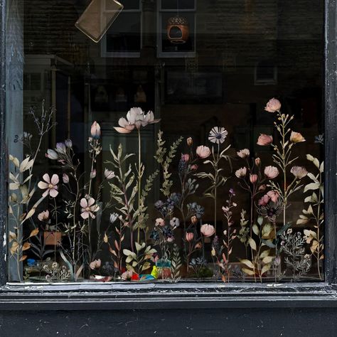 LOVINGLY DESIGNED AND PRODUCED IN THE UK BY A SMALL FAMILY BUSINESS Our Magic Botanical Flowers Shop Window Border, featuring a delicate coloured wild meadow floral design, is a great way to decorate your business window and create an eye-catching window display. Our Magic Botanical Flowers Collection is under construction, more products in this design will be coming soon. In the meantime, if you see any products in our Eucalyptus Collection that you would like in the Magic Botanical Flowers design, please do get in touch. We can do that for you no problem!STAND OUT FROM THE REST!Draw customers in with a stunning, eye-catching shop wall or window display.Our retail vinyls have been created with particular care and attention to style and design.Perfect for any business, cafe, restaurant, ha Front Store Design Entrance, Art Store Window Displays, Flower Shop Window Design, Store Window Design Inspiration, Restaurant Window Display, Book Store Window Display, Store Window Displays Ideas, Painted Store Windows, Autumn Shop Window Display