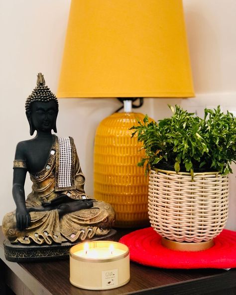 Enhance your living room decor with a charming side table, adorned with a small Buddha statue. The table also features a vibrant yellow lamp and a stylish planter, adding a touch of elegance to your sofa set designs. This versatile decorative table complements your living room's aesthetic, creating a harmonious and inviting space. Cr: nirali_thakkar24 Living Room Buddha Decor, Buddha Aesthetic Room, Buddha Statue In Living Room, Buddha Statue Decor, Indian Diy, Table Lamps For Living Room, Buddha Statue Shelf, Buddha Statue Home, Small Buddha Statue