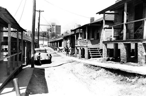 This photo, taken in the old Brooklyn neighborhood, was typical of the image often presented of Charlotte's historically black neighborhood near uptown. In reality, the area was made up of mixed-income residences and businesses. Poverty did exist, but so did spacious brick homes, movie theaters, corner stores, churches and professional buildings. Black Neighborhood, Brick Homes, Brooklyn Neighborhoods, Demolition Man, Black Life, Water Purification System, Grace Jones, Movie Theaters, Urban Renewal