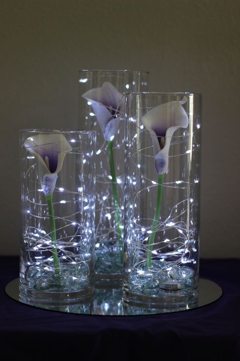 Picasso calla lilies in cylinder vases with fairy lights //Celebration Flair Eggs Ideas, Lighted Centerpieces, Rustic Wedding Decorations, Tafel Decor, Easter Centerpiece, Office Decorations, Cylinder Vase, Centerpiece Ideas, Calla Lilies