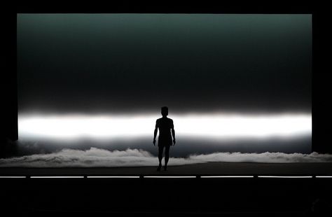 The lighting designer decided to have an intense white light behind him, thats on the bottom lower of the cya, to only show the sharp silhouette of the performer. This is great for a dance show and it helps to describe the setting, since we see the clouds forming on the bottom of the stage. Conception Scénique, Stage Lighting Design, Robert Wilson, Theatre Inspiration, Theatre Lighting, Marina Abramovic, White Lighting, Set Design Theatre, Stage Set Design