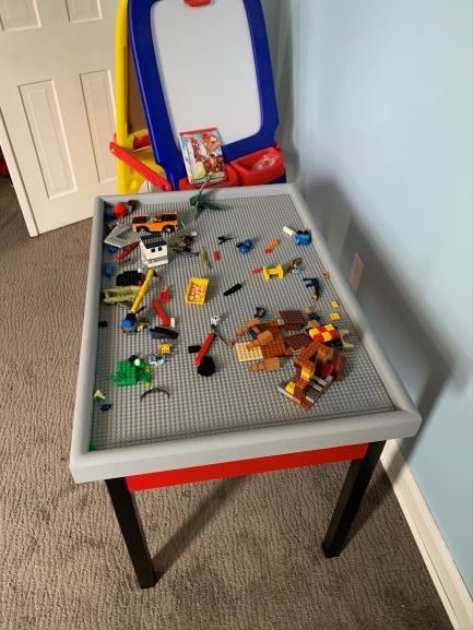 How I built a custom Lego Table with storage for under $35!  Check out all the steps I took here: https://www.justagirlwithaproject.com/building-a-lego-table/ to see if you could make something similar using scrap wood and paint you already have! Custom Lego Table, Lego Building Table, Lego Table With Storage, Lego Table Diy, Using Scrap Wood, Lego Table, Custom Lego, Table With Storage, Lego Building