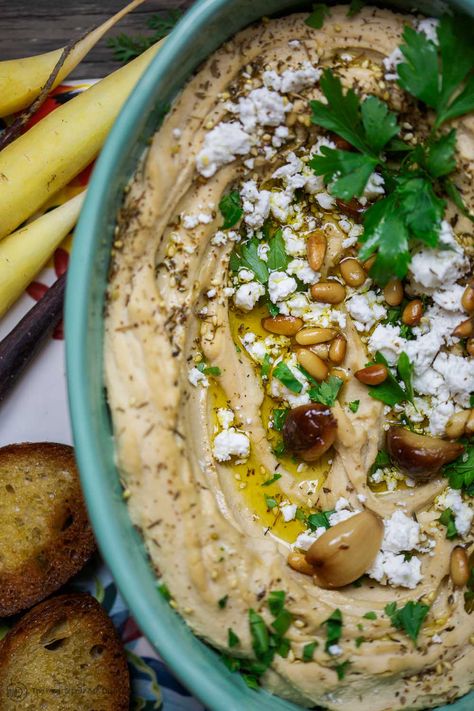 Roasted Garlic Hummus | The Mediterranean Dish. Smooth and creamy hummus dip with the perfect flavor combination. Sweet. Smoky. And just enough zing. Top it with toasted pine nuts, and feta. The best roasted garlic hummus ever from TheMediterraneanDish.com Creamy Hummus, Roasted Garlic Hummus, Garlic Hummus, Hummus Dip, Healthy Afternoon Snacks, The Mediterranean Dish, Homemade Hummus, Toasted Pine Nuts, Hummus Recipe