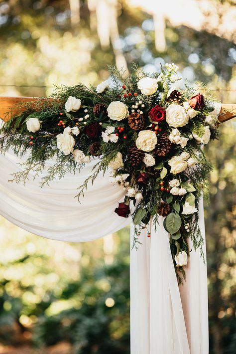 Rustic-Elegant Burgundy and Evergreen Holiday Inspired Wedding | Cross Creek Ranch - Marry Me Tampa Bay | Local, Real Wedding Inspiration & Vendor Recommendation & Reviews Winter Wedding Arch, Pine Cone Wedding, Christmas Wedding Flowers, Evergreen Wedding, Rustic Winter Wedding, Winter Wedding Bouquet, Wedding Cross, Wedding Arch Flowers, Winter Wedding Decorations