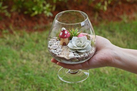 Wine Glass Terrarium Enchanted Forest Living Room, Forest Living Room, Forest Living, Water Bottle Crafts, Succulent Bowls, Glass Fairy, Liquor Bottle Crafts, Frosted Glass Design, Glitter Wine