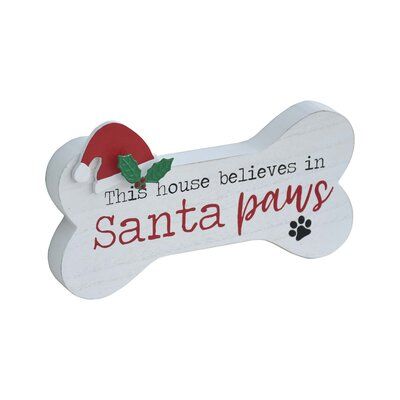 Christmas is coming even for your family dog. Add a little extra holiday fun to your home with this playful pet sign. This charming dog bone-shaped sign features a background with the words "This house believes in Santa paws" in red and black font, accented with a Santa hat and holly. This tabletop sign will add holiday cheer to your entry, living room, family room, kitchen, or dining room. Sitting nicely on a shelf, mantel, table, or counter. This cheerful and fun holiday dog sign is a great gi Santa Paws Sign, Dog Swag, Santa Dog, Christmas Tabletop Decor, Wooden Santa, Christmas Tabletop, Tabletop Signs, Wood Dog, Santa Paws