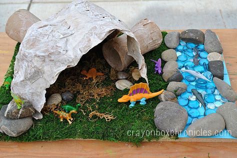 Paper Mache Dinosaur Cave by Crayon Box Chronicles.  Easy to set-up dinosaur diorama explores small world play with a paper mache cave/tunnel craft and sensory materials. Paper Mache Projects For Kids, Dino Diorama, Paper Mache Dinosaur, Dinosaur Cave, Dino Crafts, Cave Tunnel, Dinosaur Diorama, Boy Craft, Dinosaur Scene