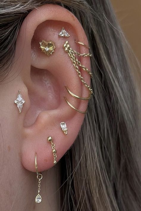 Lots Ear Piercings, Gold Earring Multiple Piercings, Mixed Gold And Silver Ear Piercings, Loaded Ear Piercing, Decorated Ears Piercings, Fully Pierced Ear, Ear Art Piercings, Industrial Alternative Piercing, Ear Curation Ideas Silver