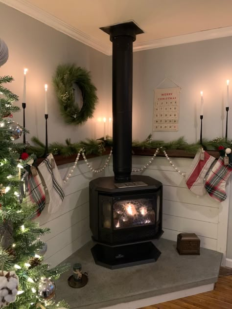 Stove Fireplace Decire, Wood Burning Stove Wood Storage, Christmas Decor Around Woodstove, Christmas Wood Stove Decor, Word Burning Stove Ideas, Pot Belly Wood Stove, Corner Stove Mantle, Corner Stove Fireplace Ideas, Wood Burning Stove Christmas Decor