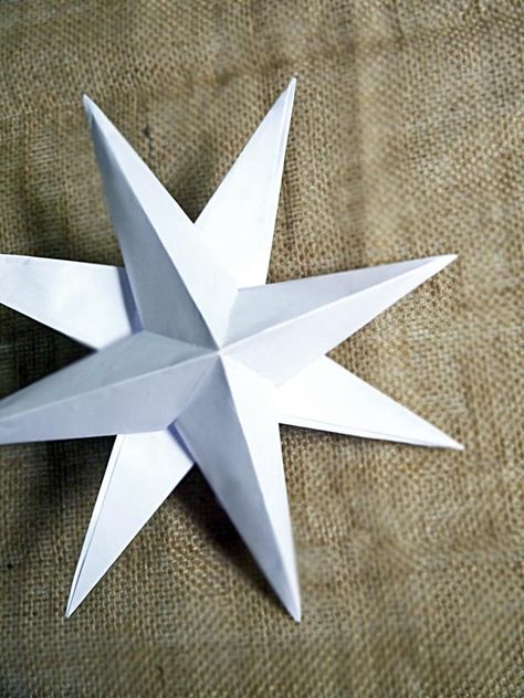 Repeat process with another sheet of white card stock. Let dry. Staggering the points of the stars, glue one star atop the other. Let dry before hanging. Hang stars on the wall in groupings for a stunning holiday display. Atomic Christmas, Diy Christmas Star, Tissue Paper Tassel Garland, Paper Decorations Diy, Tissue Paper Tassel, Christmas Stars, Origami Instructions, Origami Stars, Star Diy