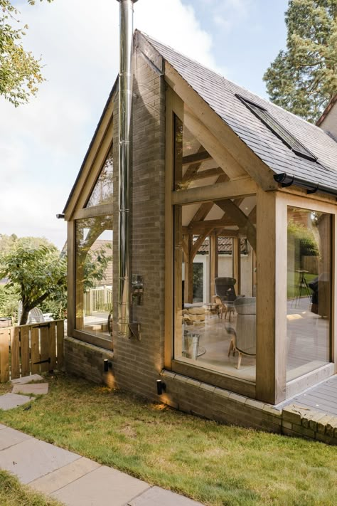 We are thrilled to present our recently completed Green Oak Frame Extension in Ceres, Fife. The oak frame design allowed us to incorporate an abundance of glass, not only flooding the space with natural light but also seamlessly connecting the indoors with the outdoors, bringing the surrounding trees right into the heart of the extended house. The weathered wood exterior also complements the existing harling of the house beautifully. Grand Designs Houses Uk, Timber Framed Extension, Red Sandstone House, Greenhouse Attached To House, Wooden Extension, Retirement Cottage, Timber Frame Extension, Grand Designs Houses, Bungalow Conversion