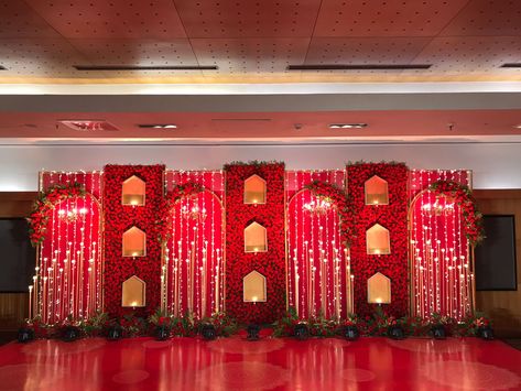 Red Wedding Stage Decor, Red Wedding Stage, Varmala Stage Decor, Indian Wedding Stage Backdrop, Wedding Stage Design Backdrop Ideas, Red Wedding Backdrop, Stacked Tile Backsplash, Indian Wedding Backdrop, Sangeet Backdrop