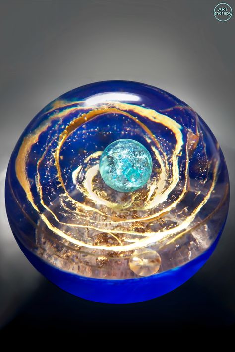 In this project, I made a resin art sphere. For the lines I used gold acrylic paints, and for the bottom of the sphere I used pearl paint, blue paint. I painted the lines in layers and filled with epoxy. After placing the ball in the center, it looks like a planet. The result is space in a sphere. Epoxy Resin Sphere, Resin Sphere Tutorial, Resin Sphere Ideas, Diy Resin Sphere, 3d Resin Art, Resin Art Diy, Sphere Art, Resin Sphere, Sphere Design