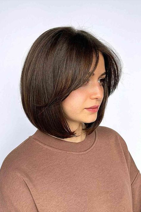 Neck-Length Thick Round Bob with Face-Framing Bangs Medium Layered Bob Haircuts, Bob Haircuts For Thick Hair, Oblong Face Hairstyles, Bob Hairstyles For Round Face, Wedge Haircut, Bob Haircut For Round Face, Short Hair Cuts For Round Faces, Haircuts For Thick Hair, Best Bob Haircuts