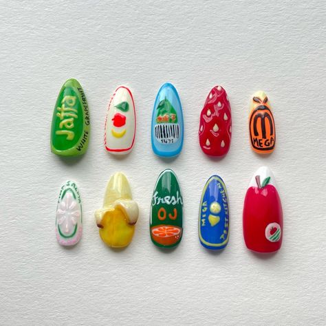 Funky fruit sticker nails 🍎 This set really tested my hand painting skills with the lettering… #yegnails #pressonnails #pressonnailsforsale #nails #nailsdesign #nailinspo #nailart #yegbusiness #chromenails #3dnails #3dnailart #fruitnails #fruitnailart Fruit Sticker Nails, Funky Colourful Nails, Fig Nails, Veggie Nails, Nail Art Letters, Weird Nail Ideas, British Nails, Eccentric Nails, Weird Nail Art