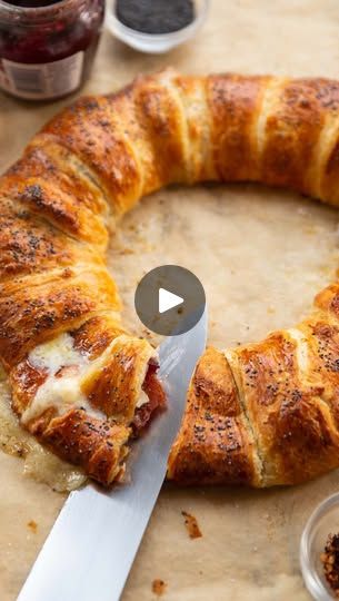 1.1M views · 68K reactions | One of my favourite things to make around this time of year! Hope you love it 😄 Chris x

BRIE BACON CRANBERRY WREATH | Serves 4-6

INGREDIENTS

6 slices of Streaky Bacon
1x 350g/12.3oz pack of Croissant Dough (keep chilled until needed)
90g / 3oz Cranberry Sauce
125g / 4oz Brie, sliced into wedges*
1 Egg, beaten for egg wash
➡️OPTIONAL:
few pinches of Chilli Flakes
few pinches of Poppy Seeds

METHOD

1️⃣Cook the bacon using your preferred method to your desired texture. Pat dry to remove excess fat and leave to cool completely to room temp. Halve each slice before needed. Preheat the oven to 180C/350F. 2️⃣Place a sheet of baking paper on a large baking tray and place a 10cm/4” ramekin/bowl in the centre. Unpack the dough and use a knife to separate each triang Brie Bacon Cranberry Wreath, Brie Wreath, Pillsbury Croissant, Cranberry Wreath, Streaky Bacon, Chris Collins, Easy Delicious Dinners, Croissant Dough, Crescent Roll Recipes