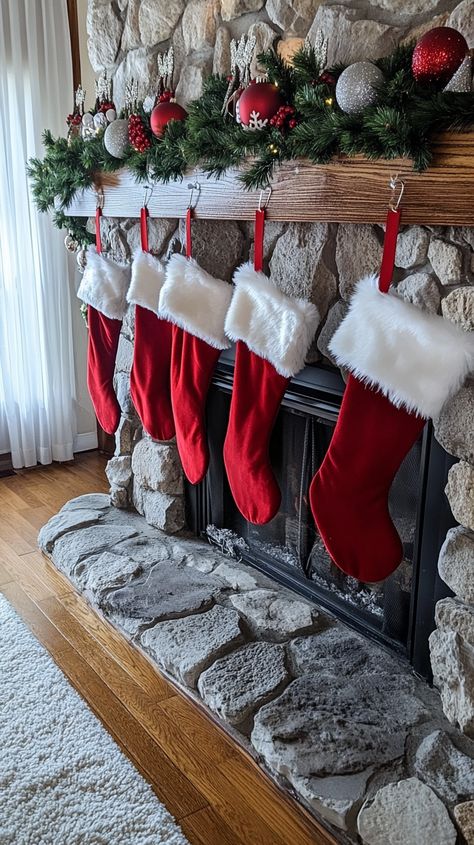 Red Christmas stockings with white fur trim hang from a fireplace in a stone-walled room, creating a festive holiday Red White Christmas Decor, Red And White Christmas Decor, Plush Ornaments, White Christmas Decor Ideas, Cozy Table, Elegant Ornaments, Holiday Living Room, Earthy Living Room, Snowy Christmas Tree