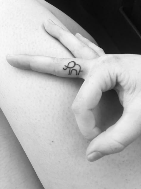 Simple outlined elephant tattoo on finger Elephant Tattoos Finger, Elephant Stick And Poke, Micro Elephant Tattoo, Tiny Elephant Tattoo Simple, Mini Tattoos Elephant, Minimal Elephant Tattoo, Elephant Outline Tattoo, Elephant Finger Tattoo, Little Elephant Tattoos