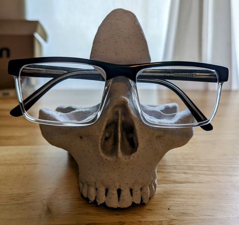 About this item This 3D skull shaped eyeglass/sunglass holder will add a bit of terror to your area with its realistic appearance. Its quirky shape will add eclectic decor to your life. Eyeglass holder stands are handmade with PLA material, which has strong stability, and high wear resistance, safe and neat. The glasses stand is very realistic and a great way to store your glasses when you want to take off your eyeglasses/sunglasses and avoid the lens getting scratched or crushed. Suitable for s Air Dry Clay Glasses Holder, Glasses Holder Clay, Clay Glasses Holder, Eyeglasses Holder Stand, Glasses Organizer, Eyeglass Holder Stand, Diy Resin Tray, 3d Skeleton, Home Office Desk Decor