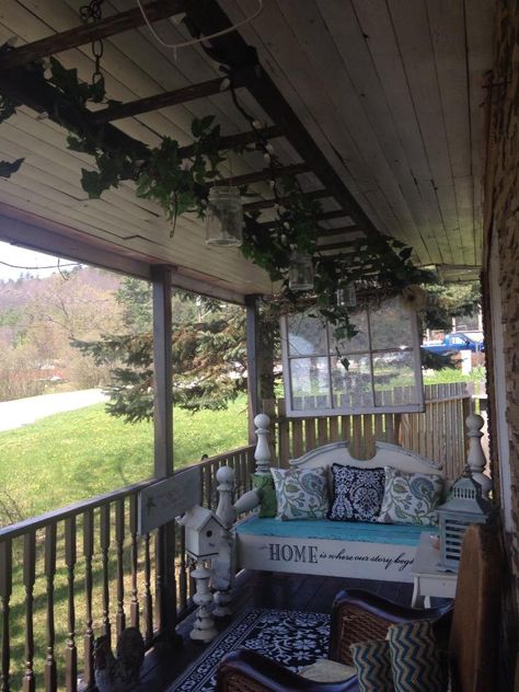 old antique wooden ladder hung from my  front porch roof I added greenery,lights and hung mason jars will post a picture of it at night Front Porch Roof, Ladder With Lights, Cabin Projects, Antique Ladder, Hanging Ladder, Old Ladder, Diy Ladder, Hanging Mason Jars, Greenery Decor