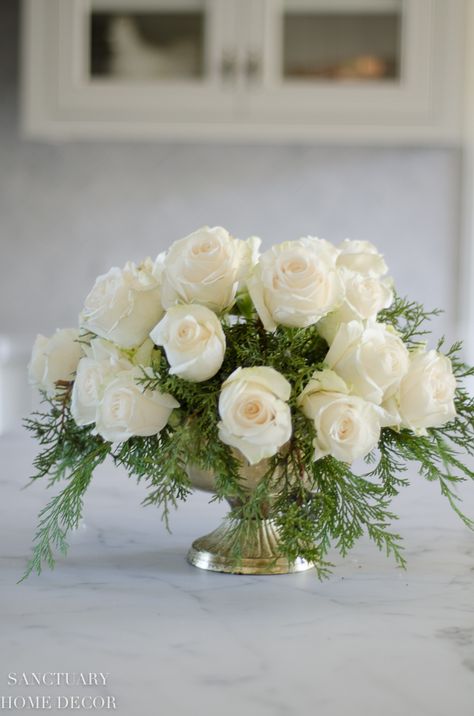 An Easy DIY White Rose and Pine Winter Centerpiece Diy White Rose Centerpiece, White Rose And Pine Centerpiece, Pine And Roses Centerpiece, Pink Winter Floral Arrangements, Winter White Flower Arrangements, White Flower Centerpieces With Greenery, Winter White Centerpieces, White Christmas Arrangements, White Poinsettia Centerpiece