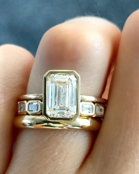 GOODSTONE on Instagram: "LOOK 1 vs. LOOK 2 vs. LOOK 3✨Details below💍  Emerald Cut diamonds have been stealing the spotlight this past month, and it’s no wonder why. Their step-cut faceting exudes a refined elegance that harks back to the Art Deco era, making them the reigning favorite shape for 2024. When it comes to finding a ring that perfectly encapsulates your love story, bezels and half-bezels offer a unique touch. Whether you prefer a full bezel, a half bezel, or none at all, the choice is yours. And if you ever want to switch things up, a ring upgrade is always an option.  ✨Penumbra Bezel Set with an Emerald Cut Opting for the full bezel ensures a stunning showcase of the diamond while providing both style and protection.  ✨East West Half Bezel with Elongated Radiant Cut Embrace a East To West Engagement Rings, Bezel Wedding Ring Stack, Bezel Stacked Wedding Rings, Emerald Cut Diamond Bezel Ring, Bezel Band Ring, Bezel Emerald Engagement Ring Stack, Emerald Bezel Engagement Ring With Band, Unique But Classic Engagement Rings, Emerald Engagement Ring Art Deco