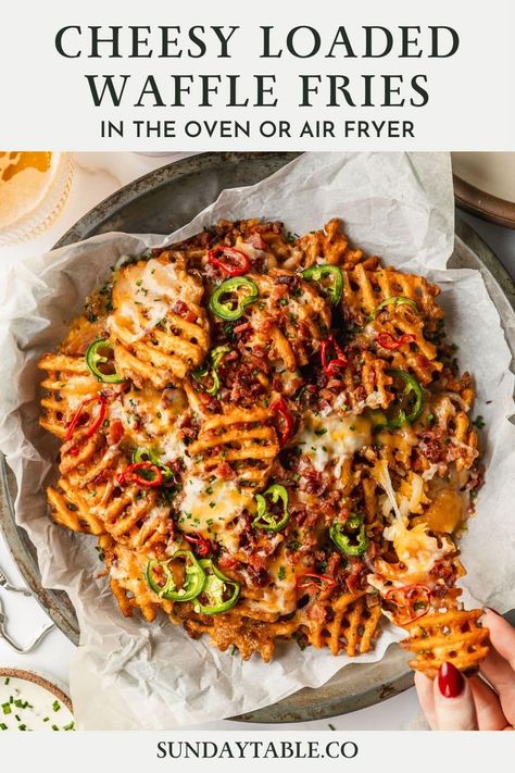 These cheesy loaded waffle fries with bacon, jalapeños, and chives are the perfect party food! Made with frozen fries, this appetizer is easy to whip up in the oven or air fryer. You can even use sweet potato fries! This is one of my favorite finger foods for a party, game day, movie night or get-together with friends. You can also top the fries with chicken, ground beef, pulled pork, or veggies for a vegetarian option. These fries are delicious with all kinds of toppings, sauces, and cold ... Loaded Waffle Fries Recipe, Pulled Pork Loaded Fries, Waffle Wings, Loaded French Fries Recipe, Fries With Chicken, Loaded Waffle Fries, Sweet Potato Waffle Fries, Waffle Fries Recipe, Holiday Bites