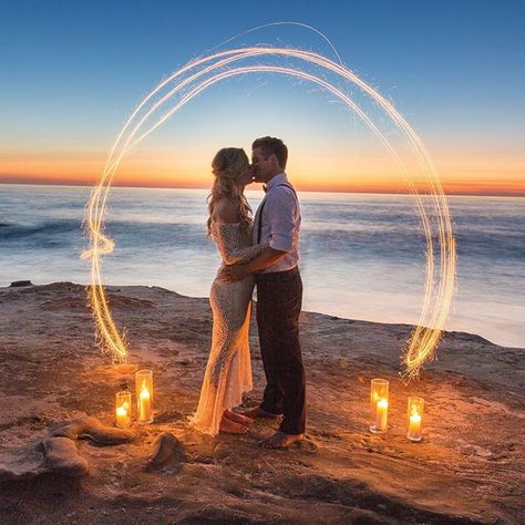 An intimate coastal elopement with a barefoot beach bride in an off the shoulder lace wedding dress greenery ceremony arch and intimate table for two set in the sand! Gorgeous magic hour and twilight photos with sparklers from Wheeland Photography and Le Champagne Projects!  Photography by @wheelandphoto | Event Planning Decor and Floral Design by @champagneprojects | Wedding Cake by @jennywennycakes | Wedding Dress from @vicidolls | Beauty Services booked though @elwynnandcass | Hair Styling by Beach Ceremony Ideas, Renewal Ceremony Ideas, Wedding In 3 Months, Greenery Ceremony, Beach Wedding Sunset, Wedding Sparklers Photos, Simple Beach Wedding Ideas, Beach Wedding Style, Coastal Elopement