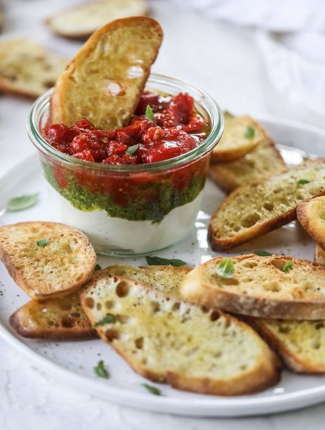 This ricotta jam jar is the perfect appetizer and snack to serve at a party! Based on the ricotta jam jar served at Nordstrom Cafe, it starts with creamy ricotta, is topped with flavorful basil pesto and a quick tomato jam. Serve with crunchy bread and dip dip dip! I howsweeteats.com #ricottajamjar #nordstrom #tomatopesto #appetizer Bread And Dip, Nordstrom Cafe, Crunchy Bread, Dip Dip, Light Appetizers, Tomato Jam, Tomato Pesto, At A Party, Meals In A Jar