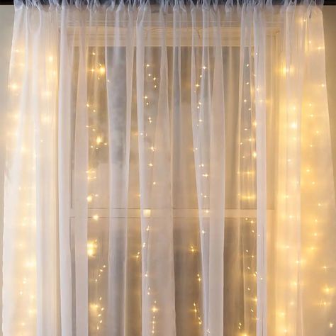 Twinkle outdoor lights and cozy indoor space – things that can set even a dull and gloomy mood. Isn’t it all you need when you come back home from a long exhausting day? Now is the time to swap your typical burned-out lightbulbs with fancy fairy curtain lights to get a welcoming vibe out of your space. Our hanging string lights can create a magical view in your room, making you want to snuggle in the bed with your partner. However, their usage isn’t limited to your indoor space. In fact, they ca Lighted Backdrop, Unique String Lights, Fairy Curtain Lights, Fairy Light Curtain, Unicorn Rooms, Ramadan Vibes, Hanging String Lights, Magical Light, Led Curtain Lights