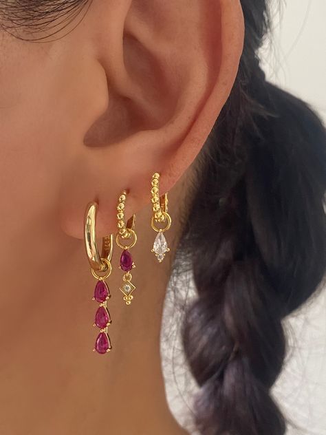 This gorgeous set comes with • 1 Pair of 3 Teardrop Pink charm with 17mm Hoop Material: 18k Gold plated on 925 sterling silver, AAAAA Cubic Zirconia • 1 Pair of Pink Teardrop charm with 15mm Princess Hoop Material: 18k Gold plated on 925 sterling silver, Cubic Zirconia • 1 Pair of Single Clear charm with 12mm Princess Hoop Material: 18k Gold plated on 925 sterling silver, AAAAA Cubic Zirconia • 1 Anett Gift Box HypoallergenicNickel free and Lead free 3 Earring Set, Colorful Gold Earrings, Pink Earring Stack, Cool Gold Earrings, Pink Earrings Aesthetic, Earring Stack Ideas, Pretty Stacks, Jewelry Colourful, Earrings Stack