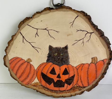 Woodburned basswood slice with a black cat and pumpkins. Painted with acrylics. Hand drawn then burned. No stencil or pattern used. All original art. Measures approximately 11 x 9 x 3/4" Fall Pyrography, Wood Burning Art Patterns, Painting Pumpkins, Woodburning Projects, 2024 Halloween, Wood Burning Crafts, Painted Christmas Ornaments, Ornament Ideas, Wood Burning Art