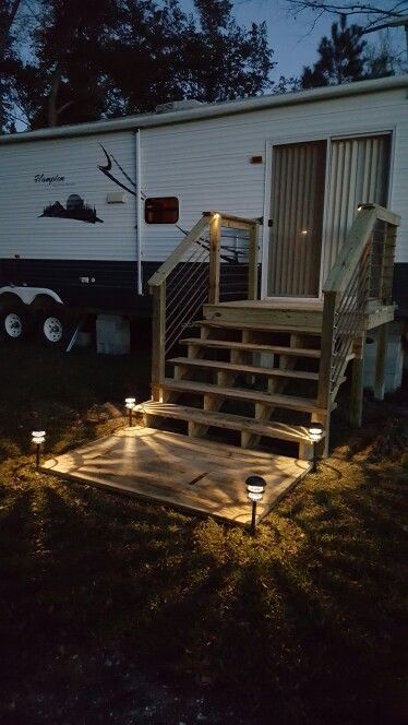 RV deck with landing and rebar railing Rv Steps Ideas, Rv Patio Ideas, Porch For Camper, Campsite Decorating, Camper Steps, Trailer Deck, Rv Patio, Rv Lots, Camper Trailer Remodel