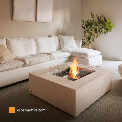 When it comes to interior design especially in smaller spaces, less is often more. In this design, the simple use of neutral colors contrasted with hints of nature, and a dazzling fire element creates a welcoming atmosphere for friends and family to unwind. Visit www.ecosmartfire.com for more #designinspiration from around the world. #ecosmartfire #fireplace #firetable #ethanol #ecofriendly #interiordesign Indoor Fire Pit, Outdoor Fire Pit Table, Wood Fire Pit, Ethanol Fireplace, Bioethanol Fireplace, Concrete Fire Pits, Concrete Color, Fire Table, Fire Pit Table