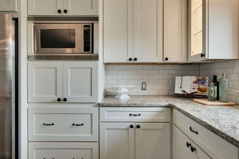 6 Perfect Places to Put the Microwave in Your New Kitchen White Kitchen Bronze Hardware, Bronze Kitchen Hardware, Microwave Wall Cabinet, Kitchen Cabinets Knobs And Pulls, 10x10 Kitchen, White Shaker Kitchen Cabinets, Microwave Cabinet, White Shaker Kitchen, Bronze Kitchen